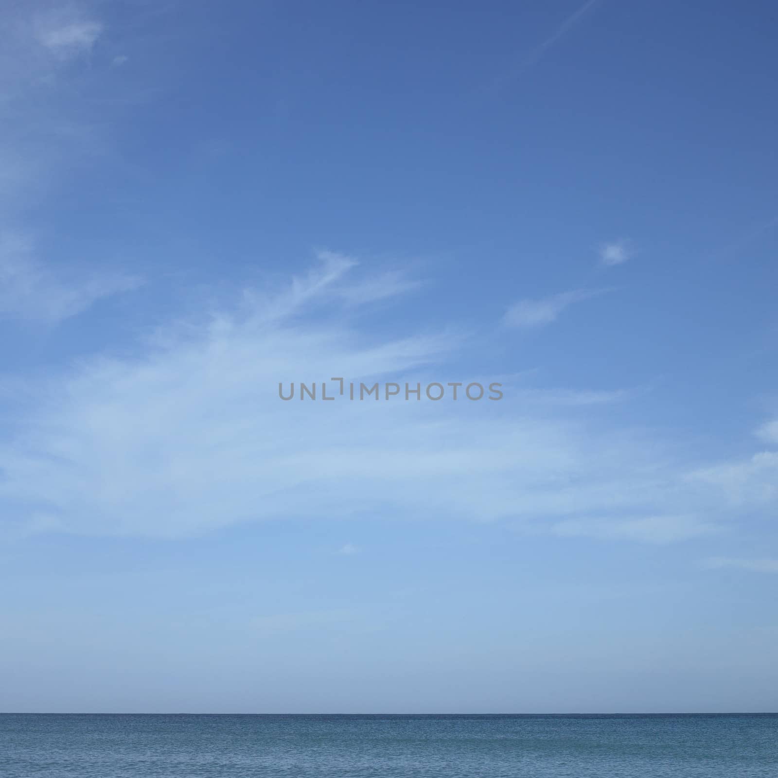 Turquoise ocean with blue sky and white clouds