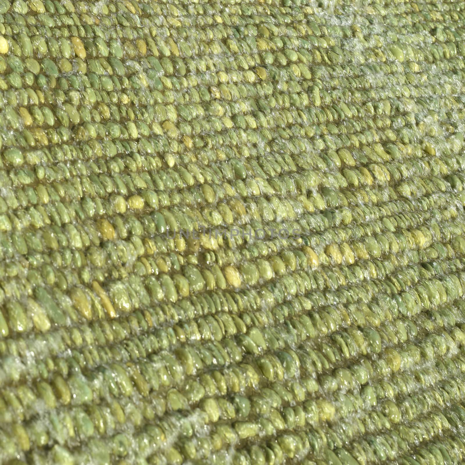 Cascade of water over green pebbles