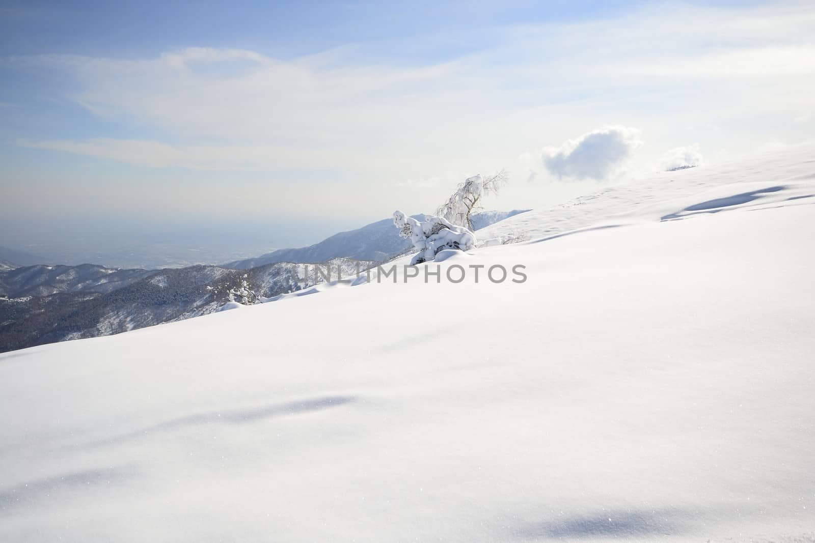 Candid off-piste ski slope in scenic background of high mountain peak