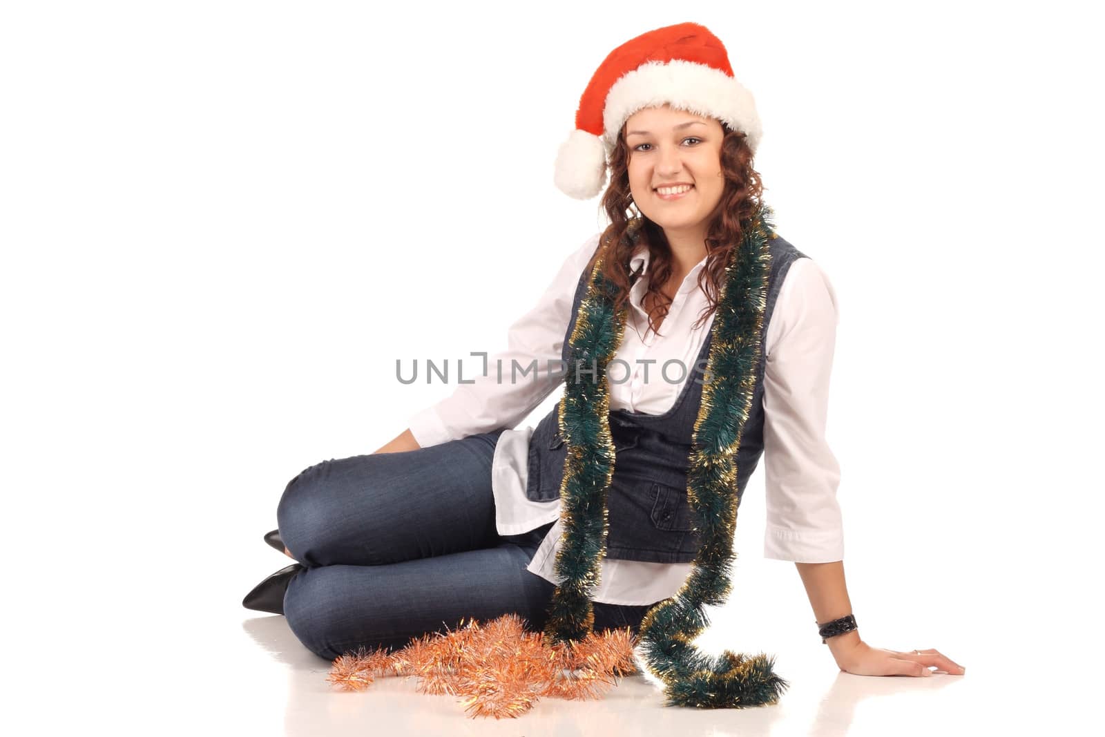 Girl in a santa hat with christmas decoration by dedmorozz
