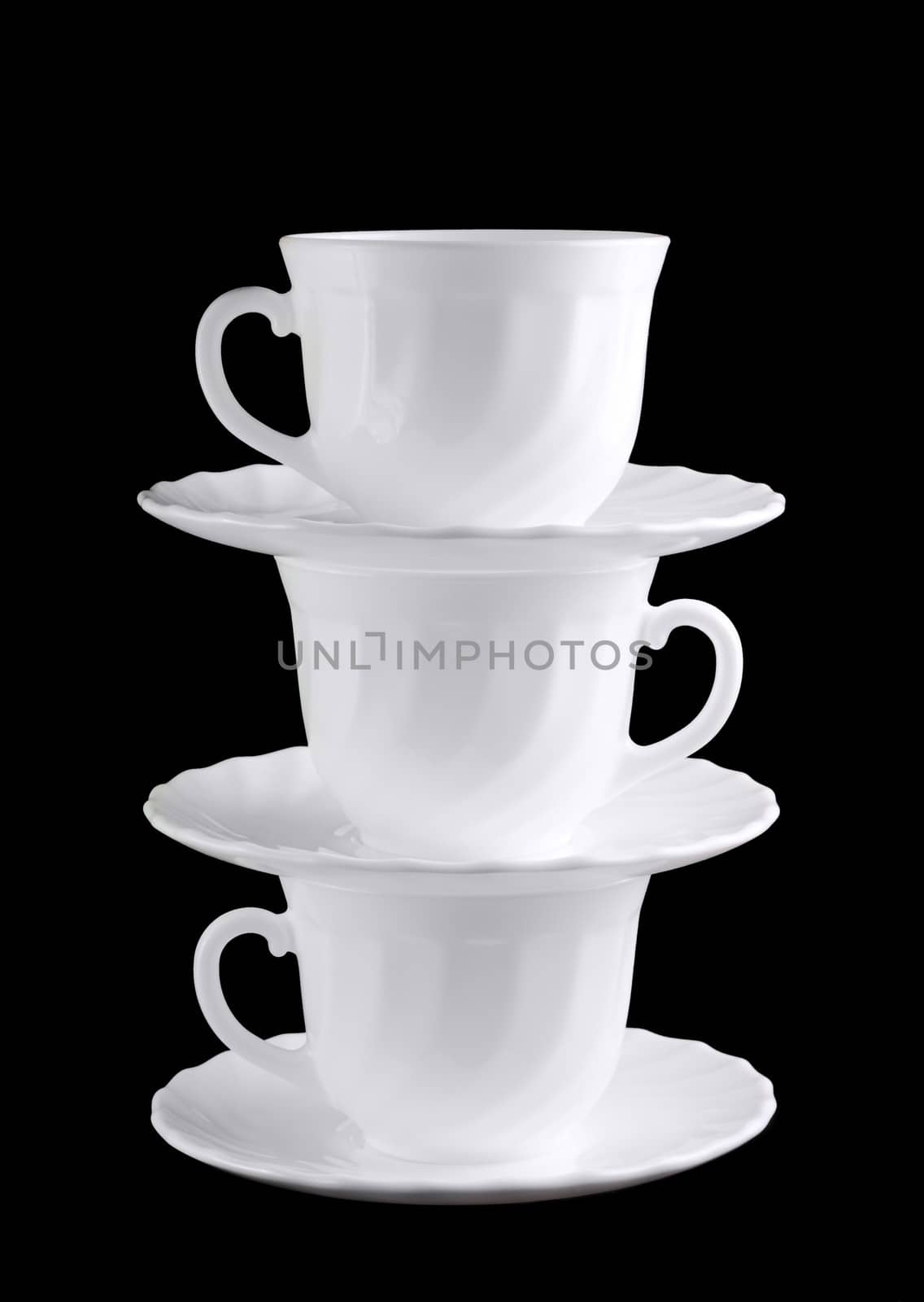 Pile of white cups isolated at the dark background