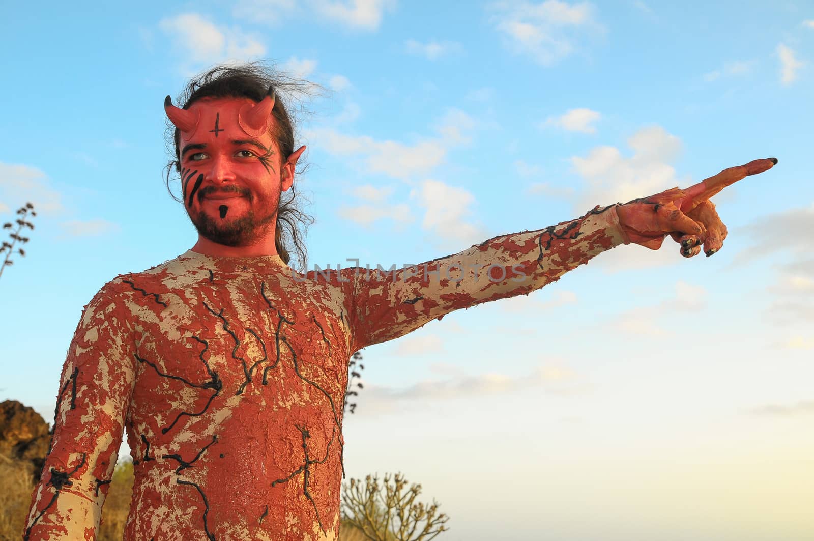 Latin American Man with Long Hairs Masked as a Devil in the Desert