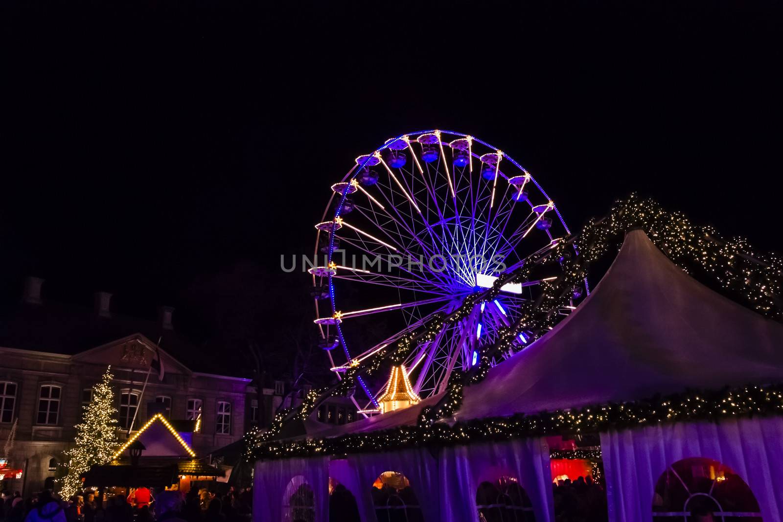 Turning Ferris wheel on a christmas market, Maastricht, the Neth by Tetyana