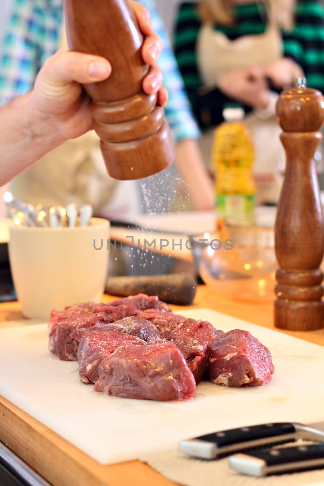 Man is salting a meat by dedmorozz