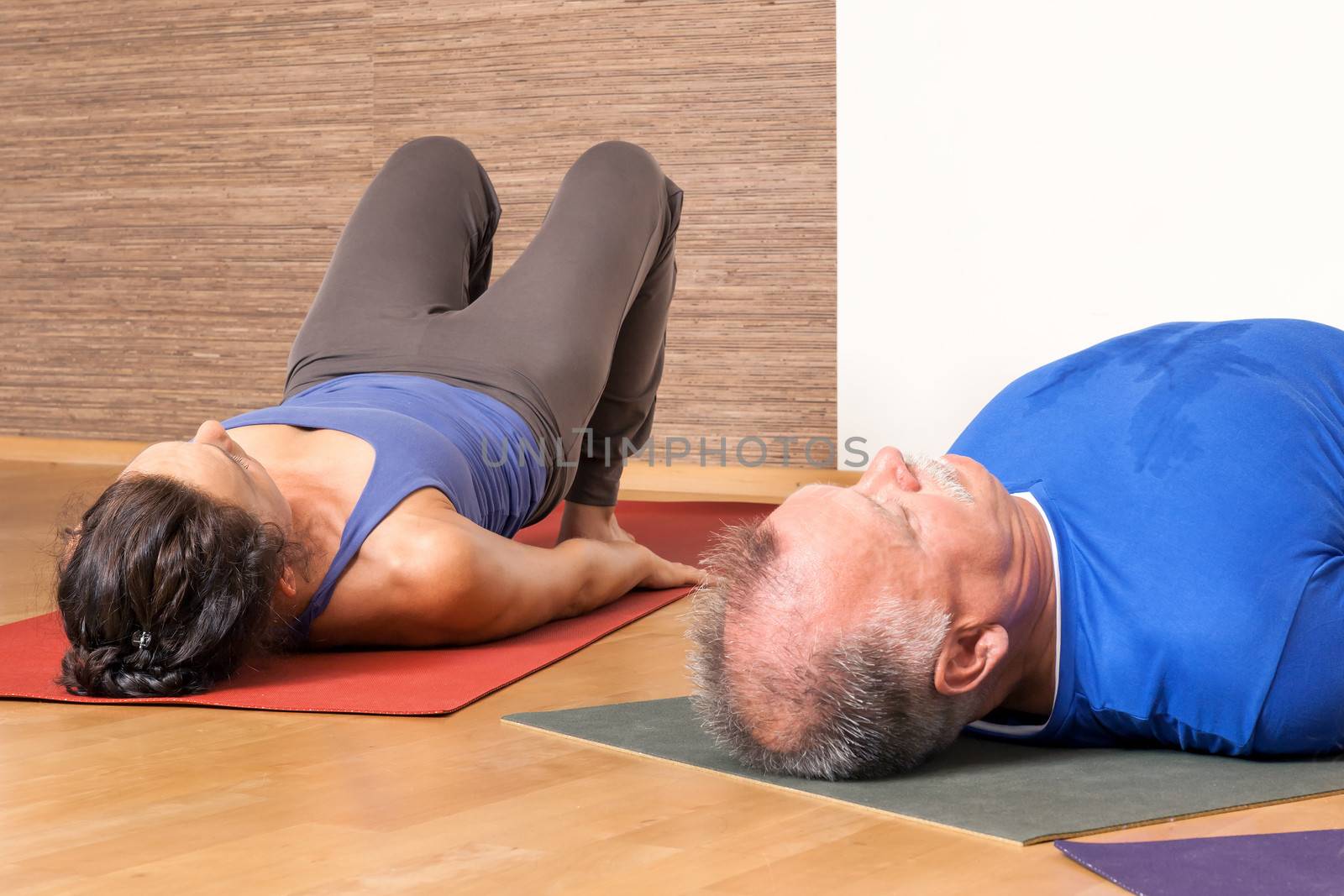 An image of some people doing yoga exercises - Setu Bandha Sarvangasana