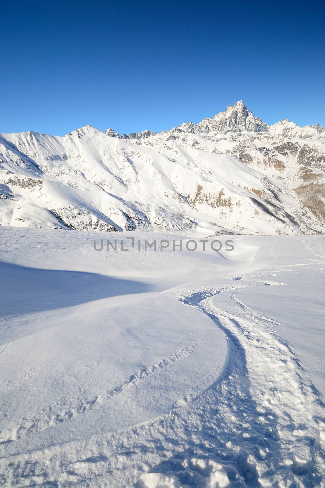 Ski touring (back country skiing) in majestic high mountain scenery, italian Alps