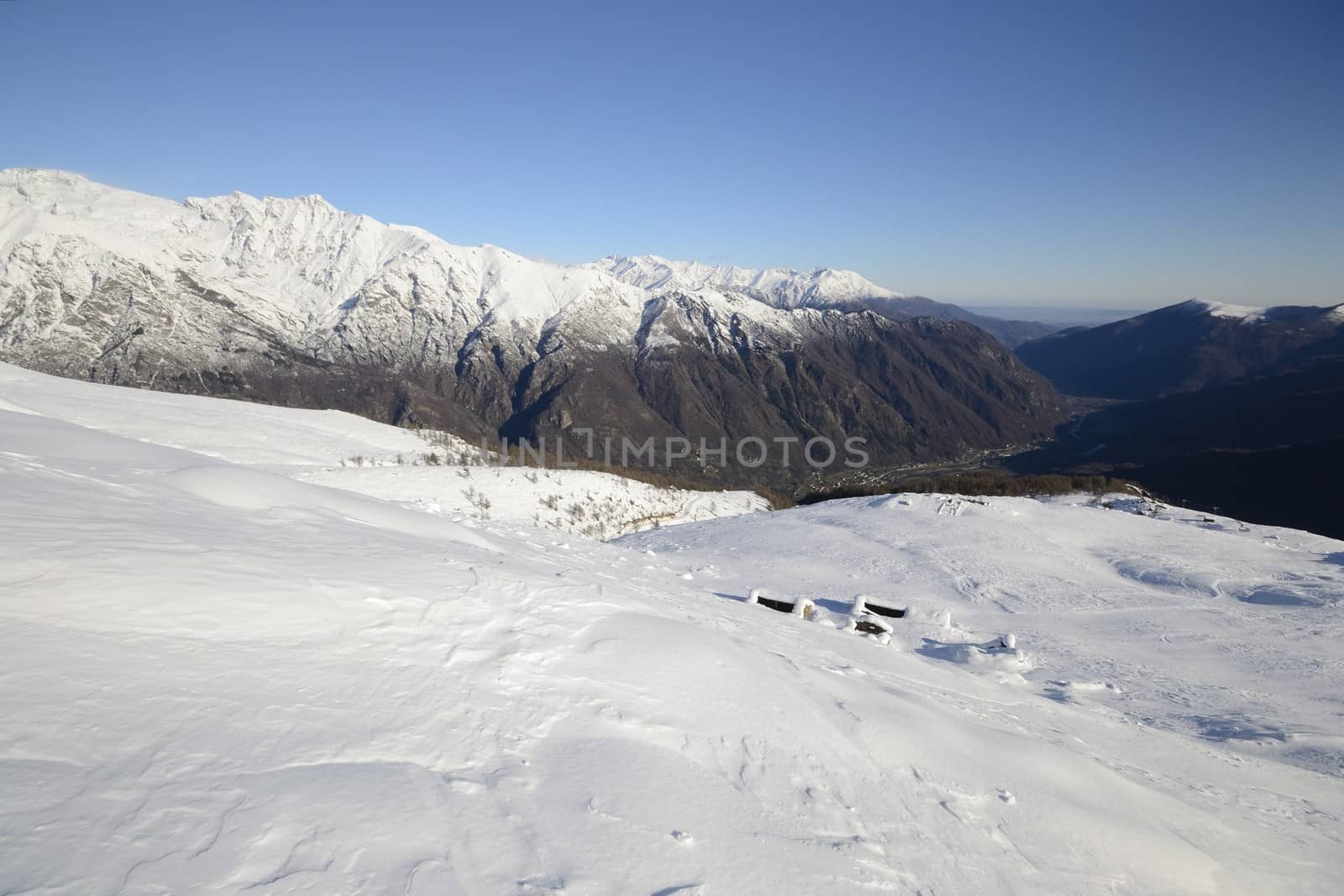 Old pasture huts in scenic winter background by fbxx