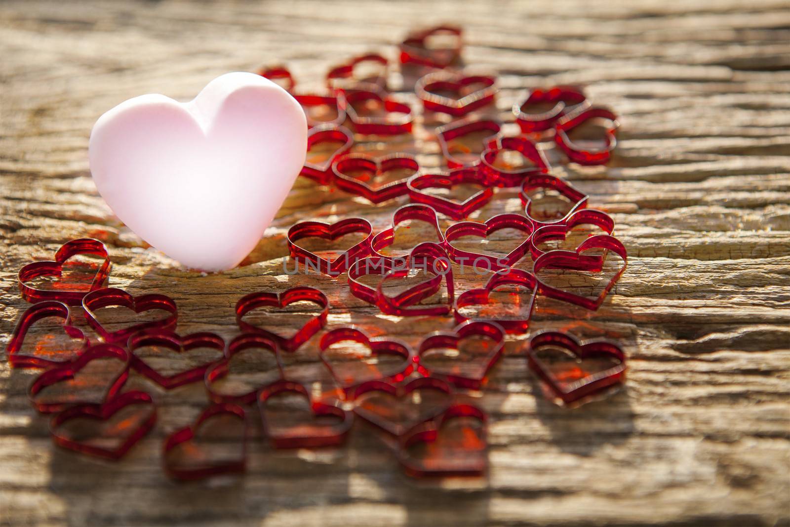 beautiful pink heart icon with lovely red heart on old wood textured background  by shallow depth of field photography technique  use for valentine day and love topic background 