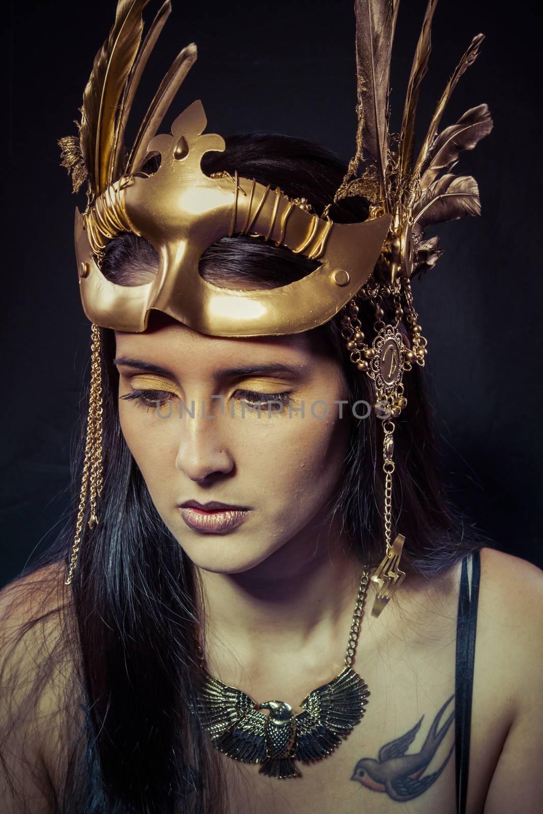Tattoo, Warrior woman with gold mask, long hair brunette. Long hair. Profile. Studio shot