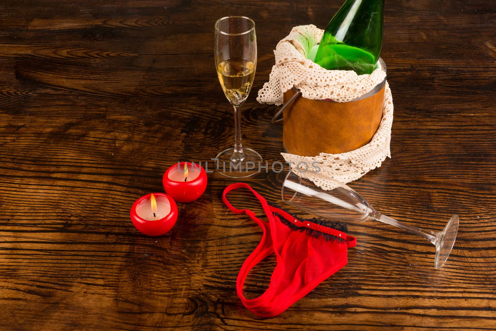 Champagne, glasses and underwear scattered in a party aftermath