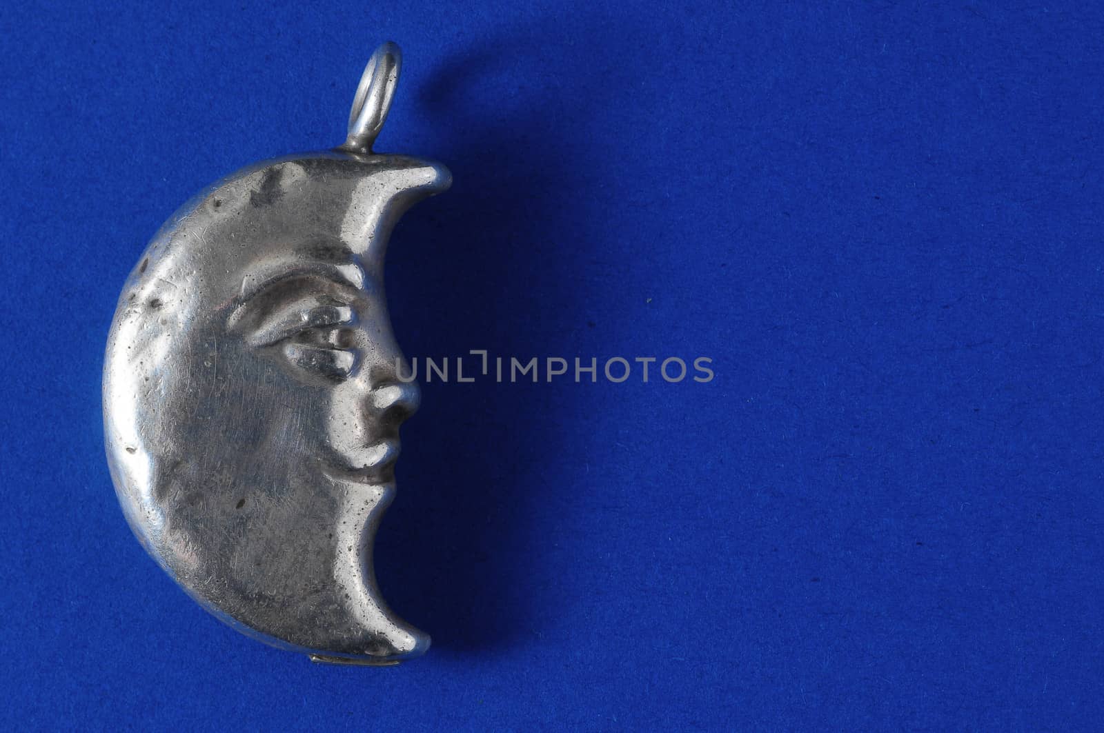 Half Moon Silver Jewel over a Colored Background
