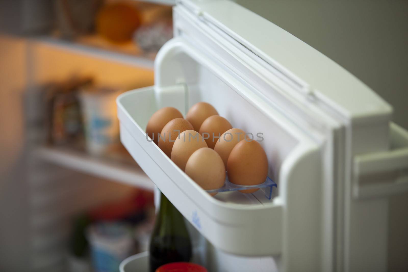 Eggs in the fridge by wellphoto