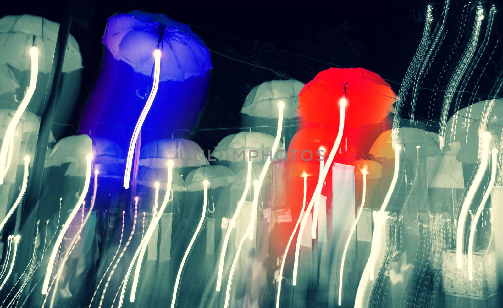 speed of umbrellas neon light in the night sky