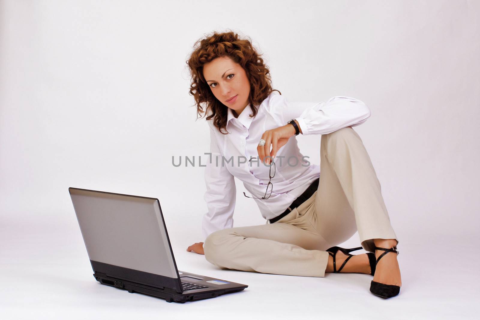 portrait of  a young girl with a lap top at home on the floor