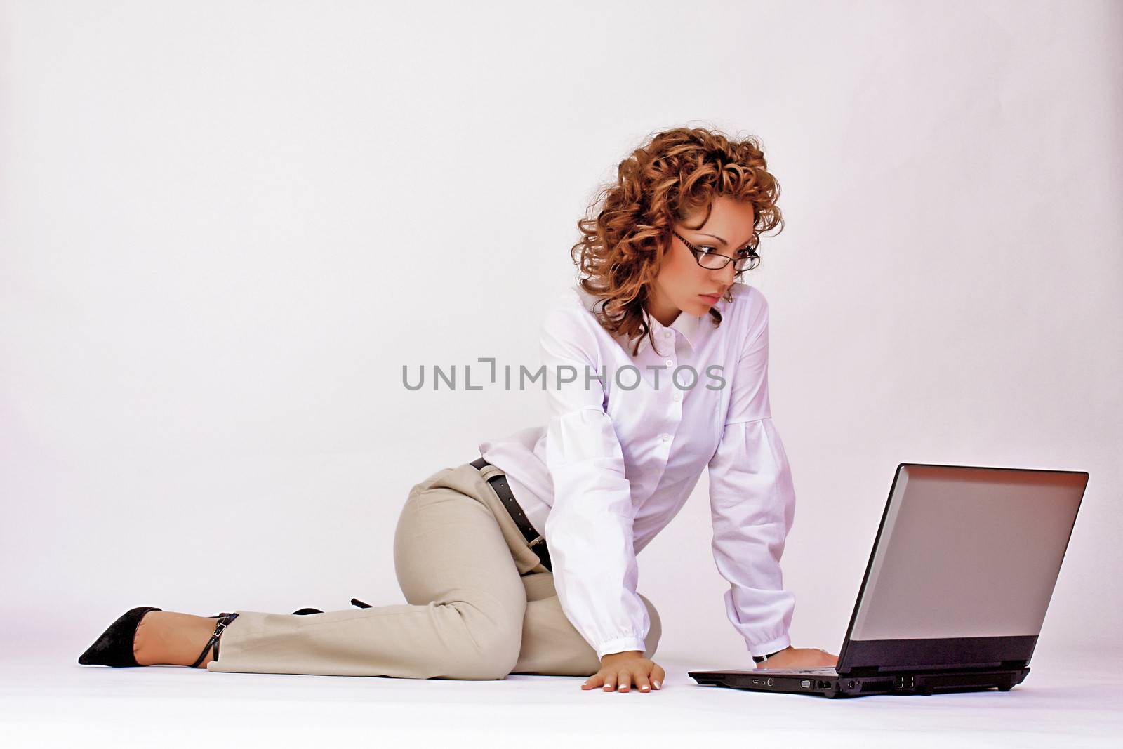 portrait of  a young girl with a lap top at home on the floor