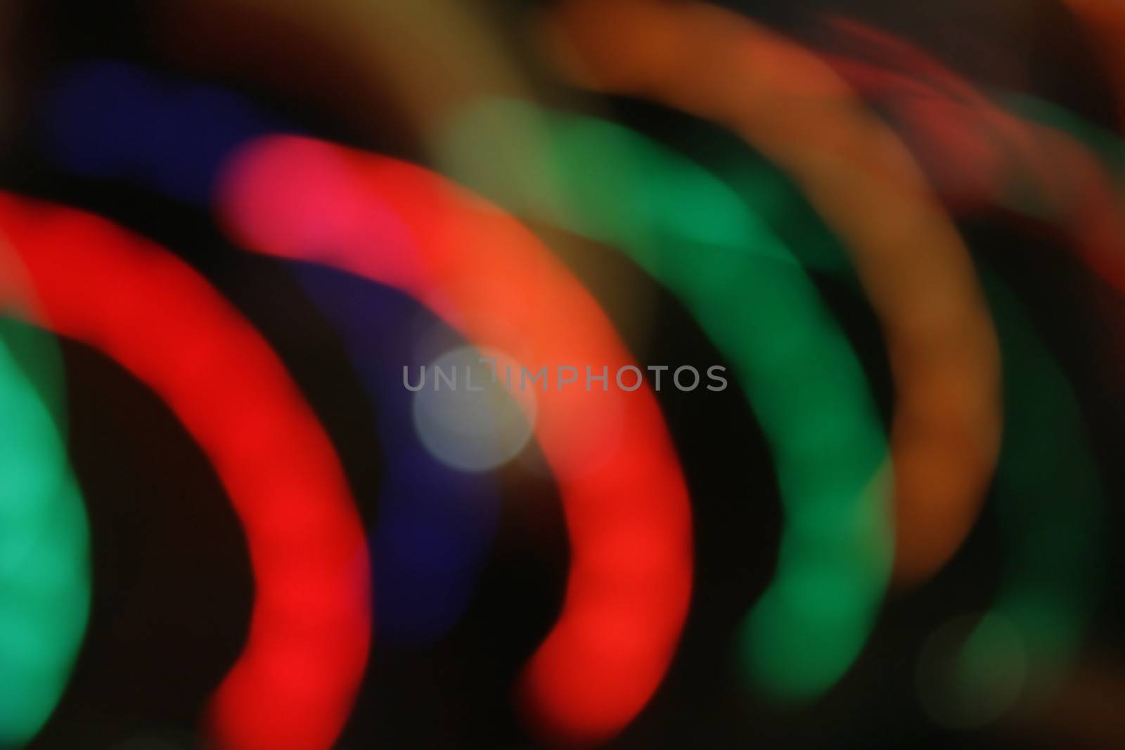 Lights blur motion in semi-circles on black