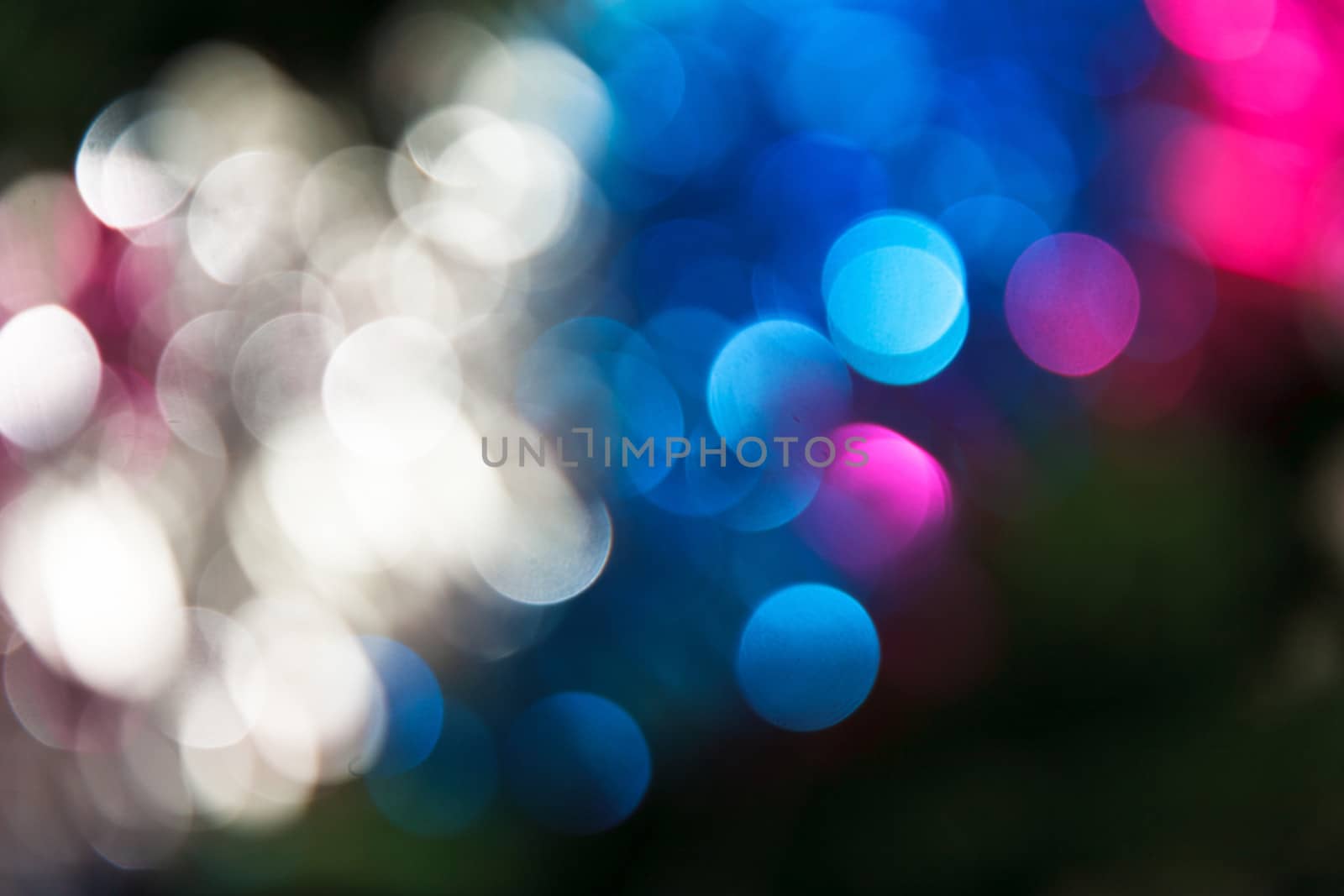 Abstract christmas background. Holiday colored lights unfocused