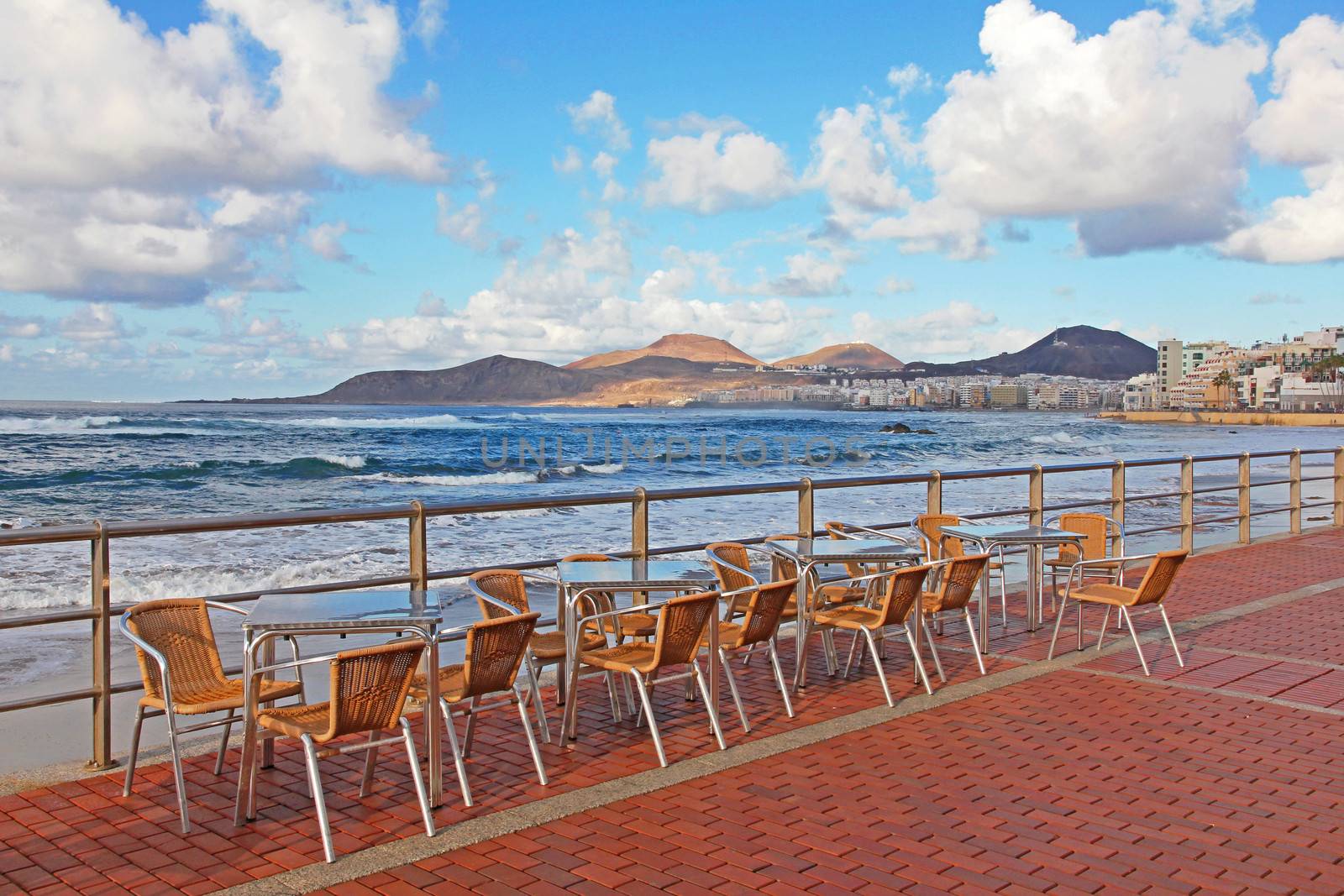 Spain. Canary Islands. Gran Canaria island. Las Palmas de Gran Canaria city. An open-air cafe on the Las Canteras beach at sunset