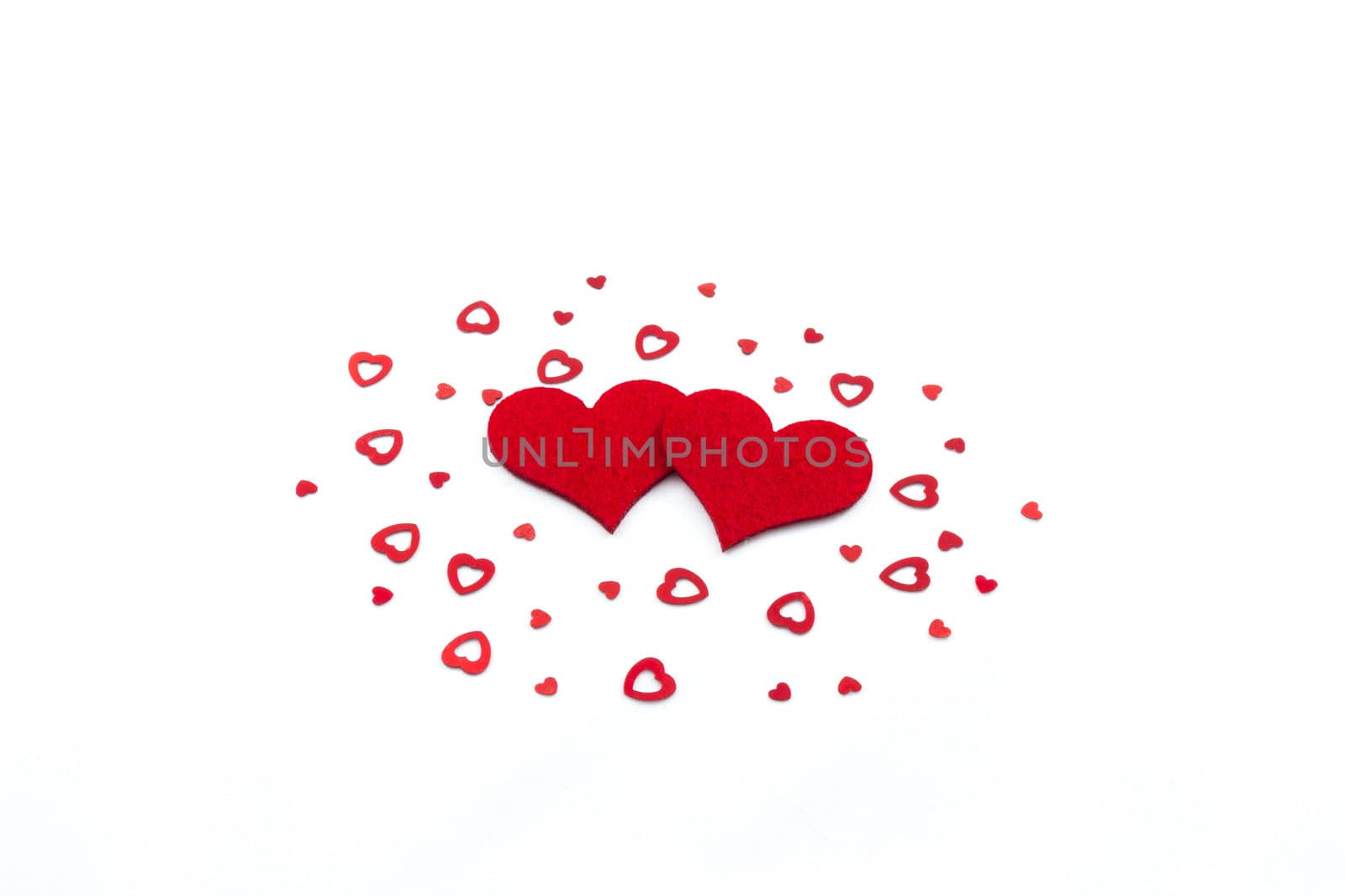 Big and small heart decorations on white background
