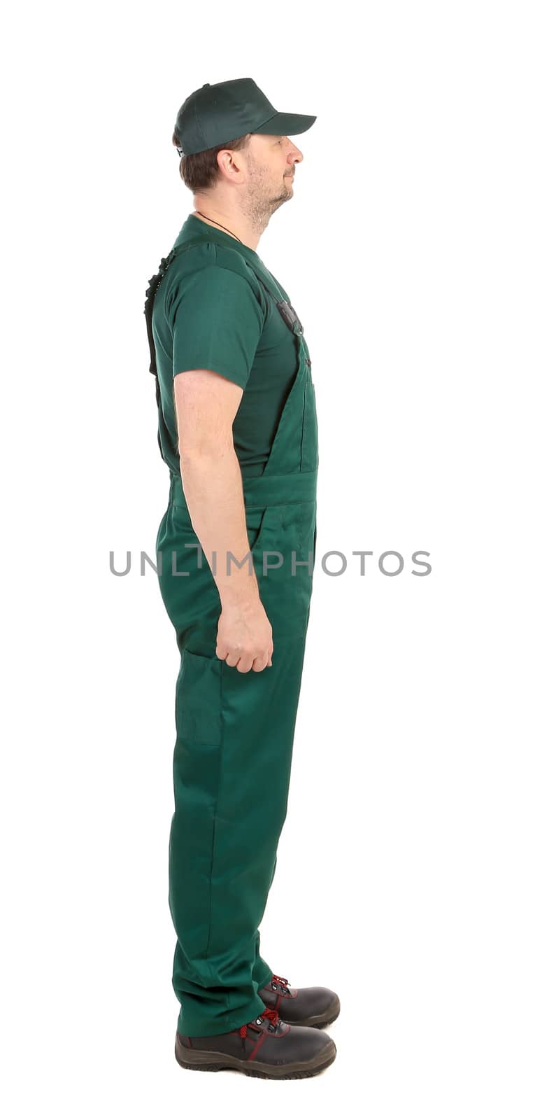 Side view. Worker in green overalls. Isolated on a white background