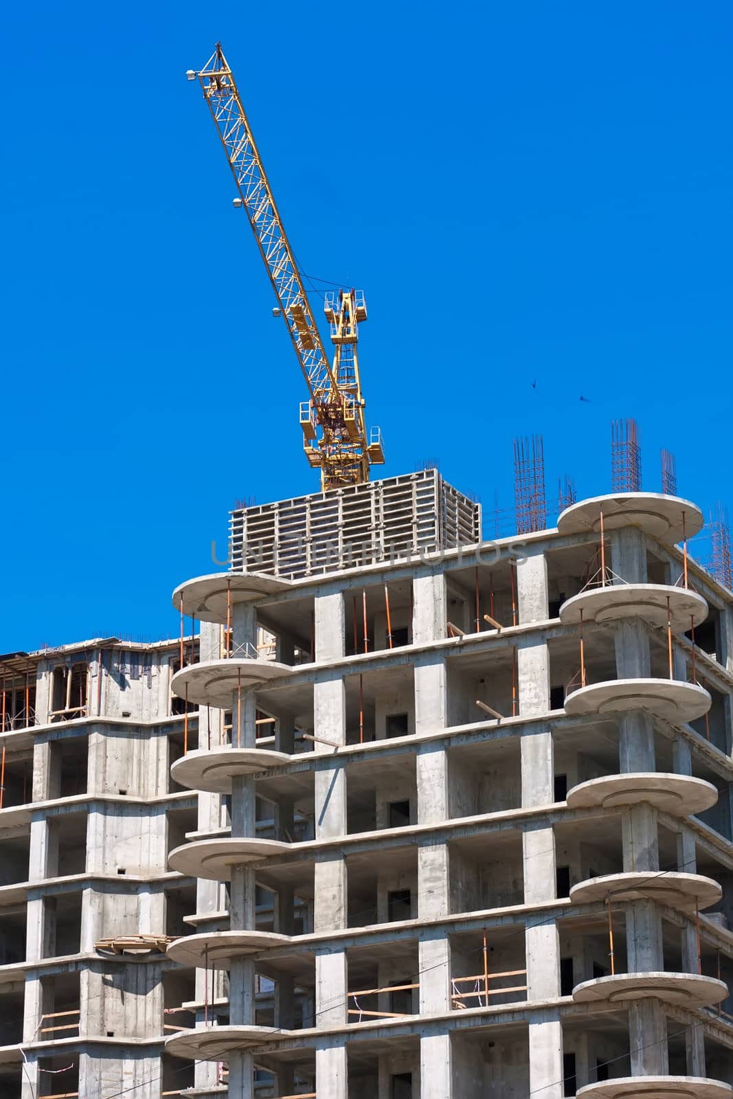 Construction of modern apartment building under blue sky