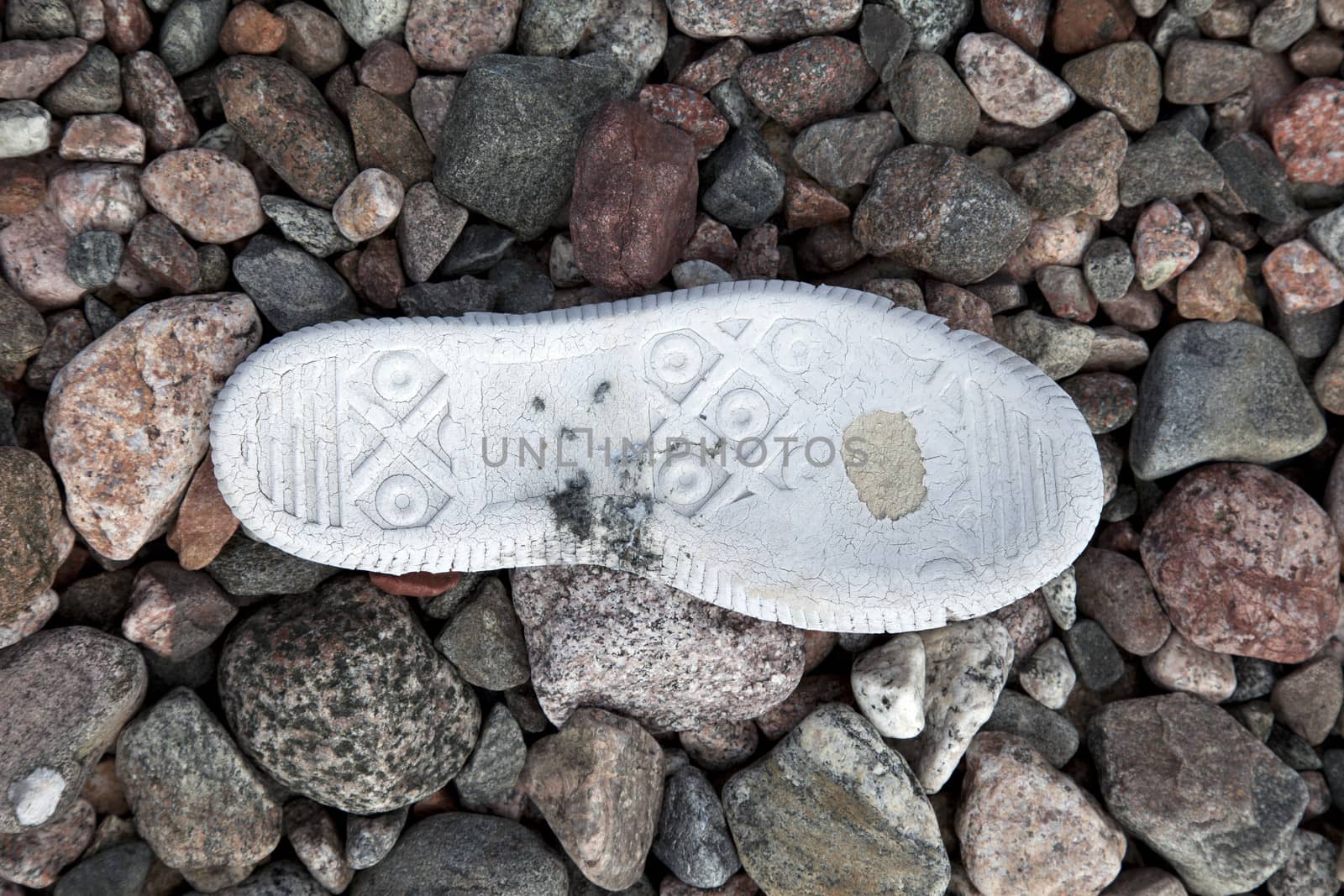 Old tennis shoe on the stone background