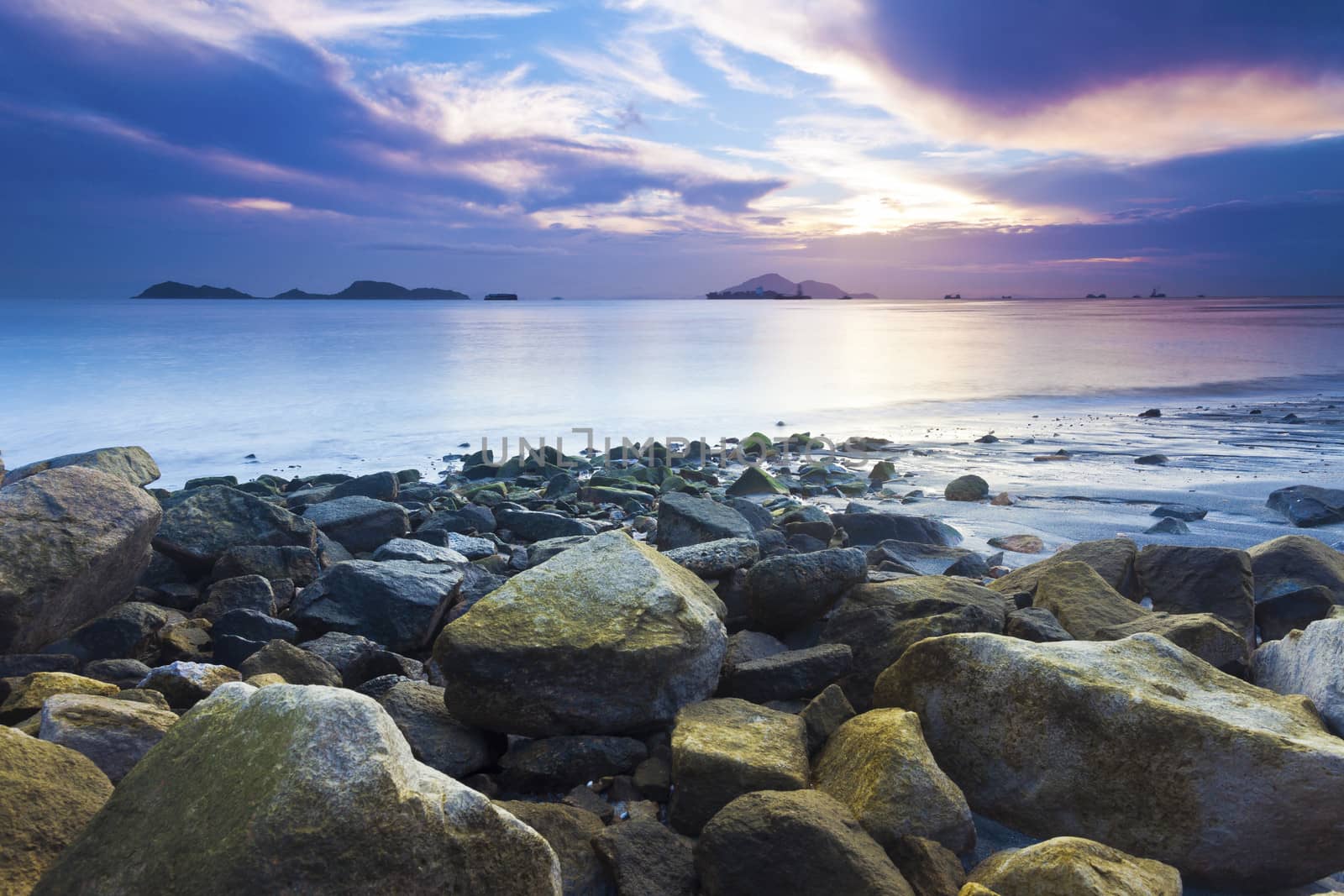 Sea stones along coast at sunset