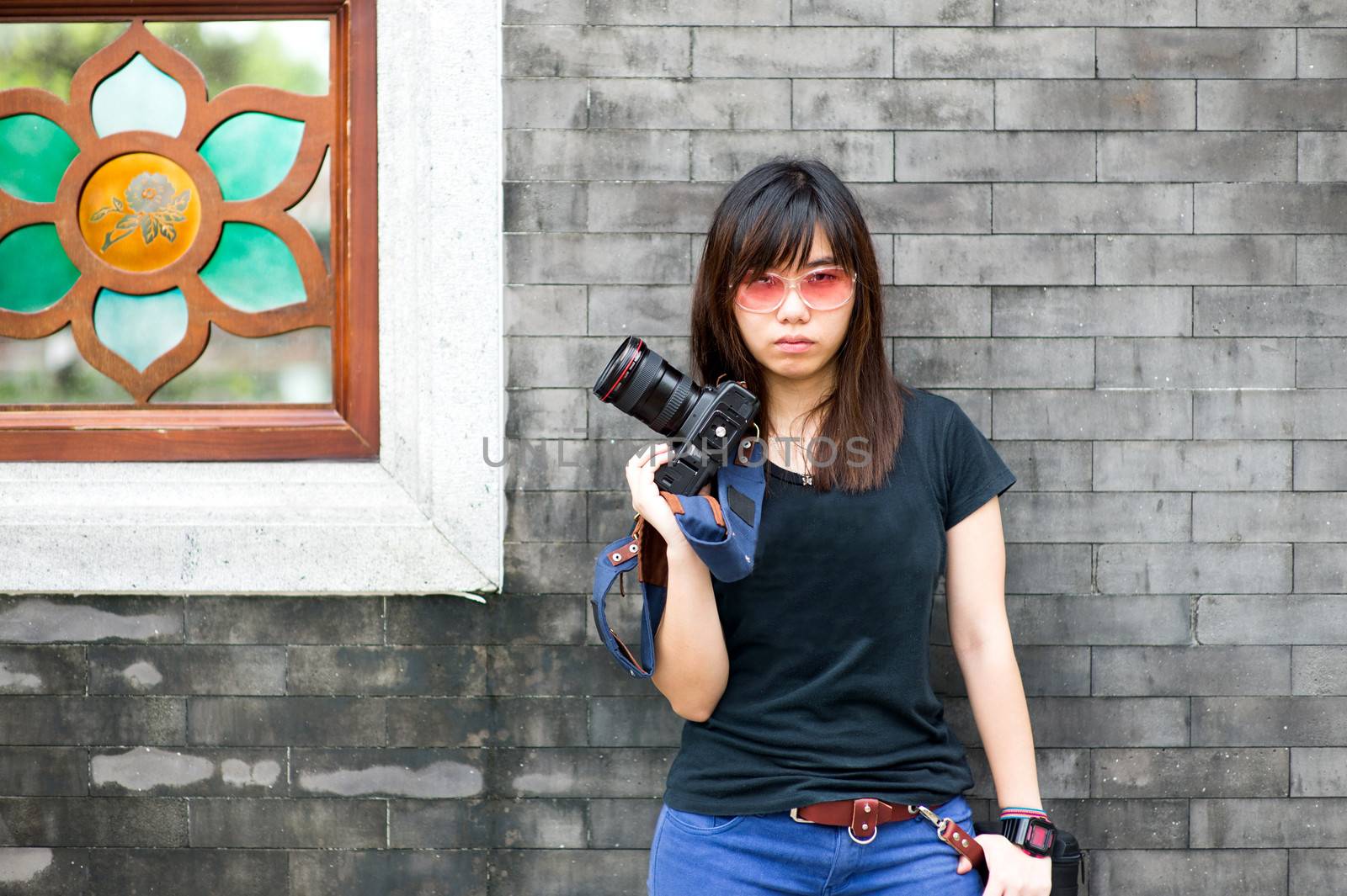 Fashion of a girl wearing a striped holding the camera