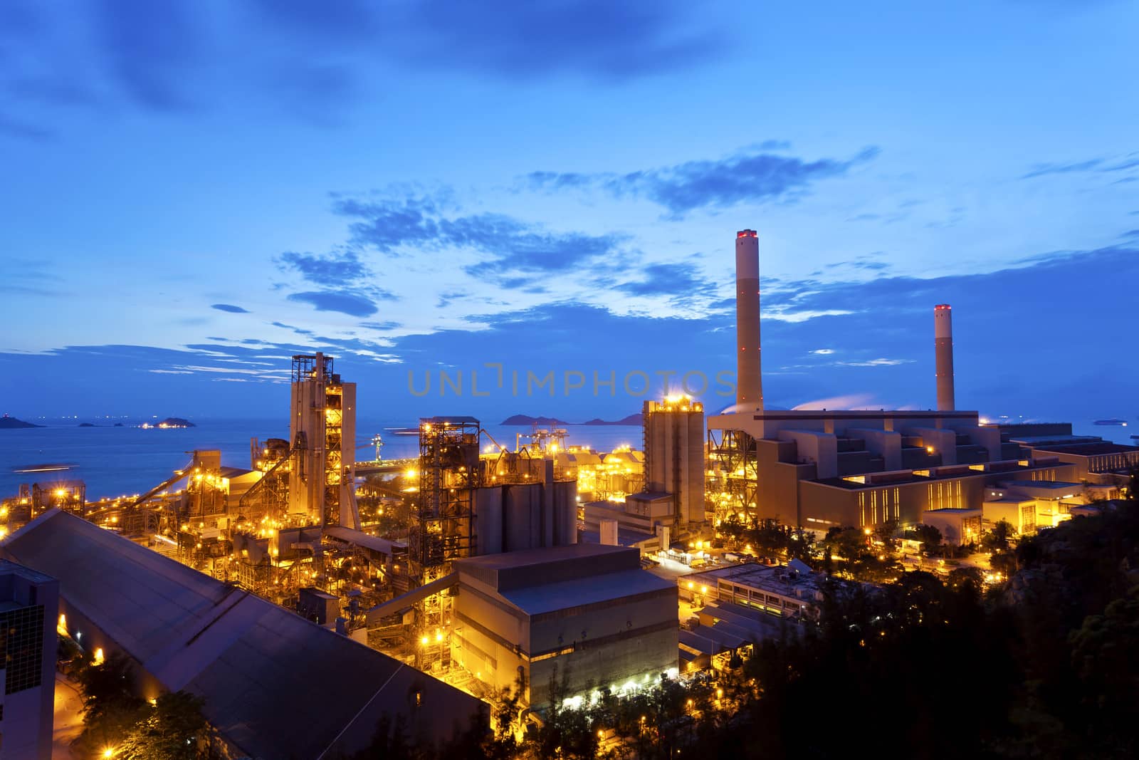 Petrochemical oil refinery plant at night by kawing921