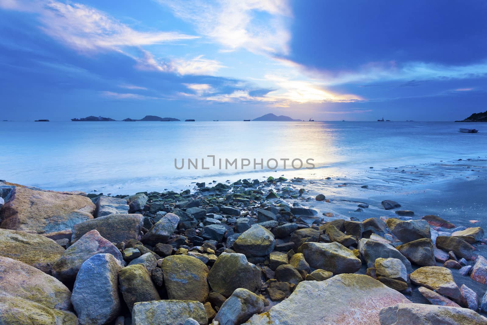 Sunset coast with sea stones background by kawing921