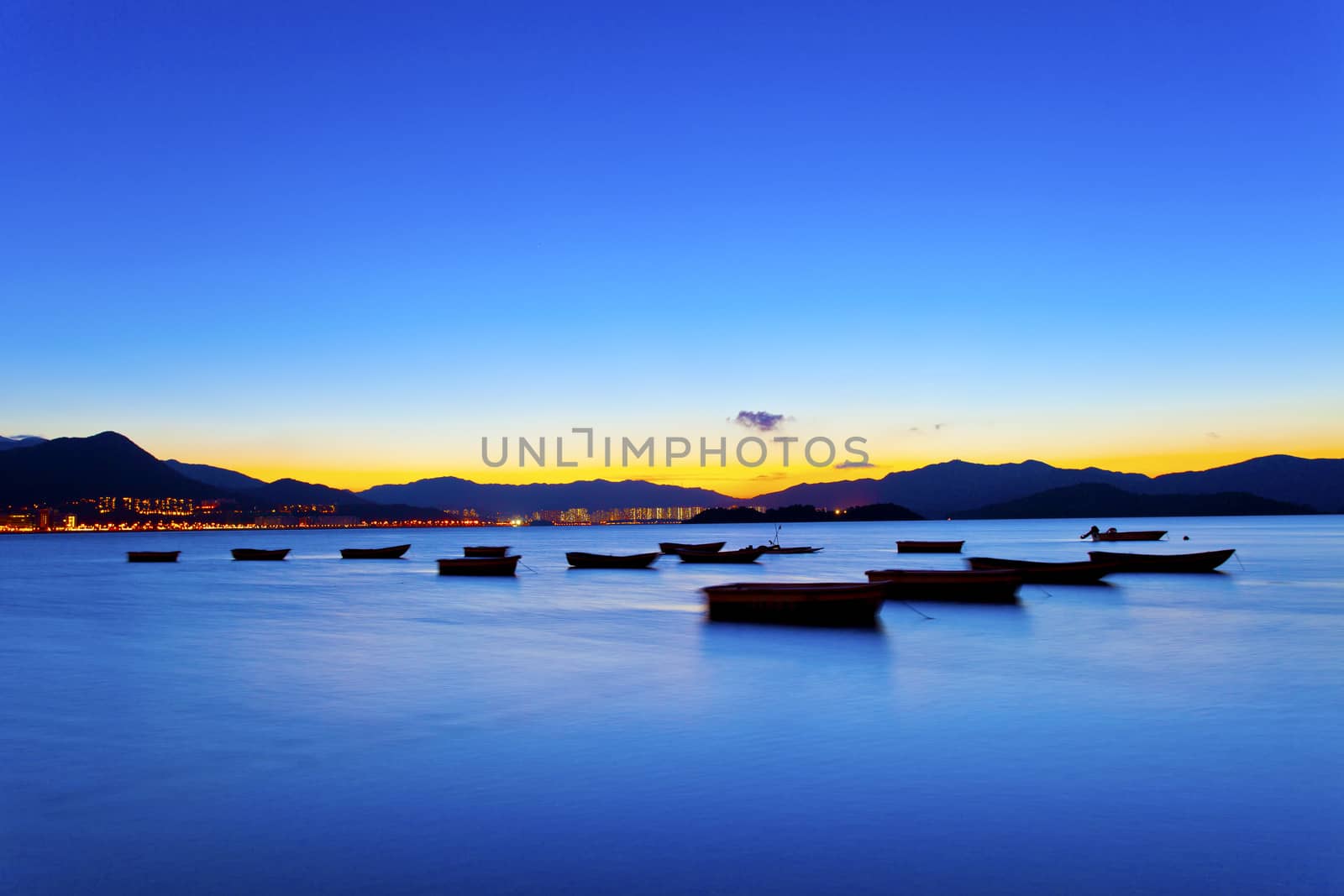 Sunset view by the coast with boats