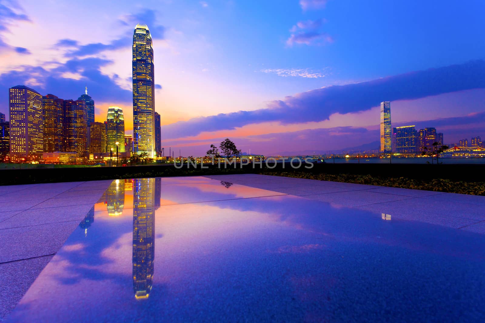 Hong Kong harbor with modern buildings at sunset