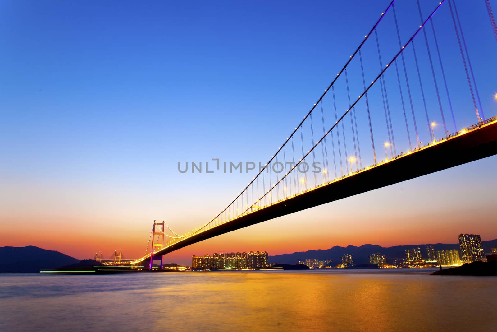 Modern bridge connecting the city at sunset by kawing921