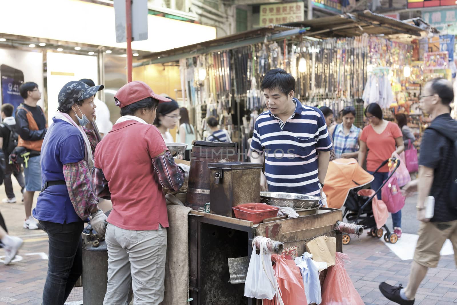 HONG KONG, OCT 4: Hawkers sale the food on the sidewalk road in Sham shui Po on October 4, 2013. Sham Shui Po was one of the earliest districts in Hong Kong to be developed.