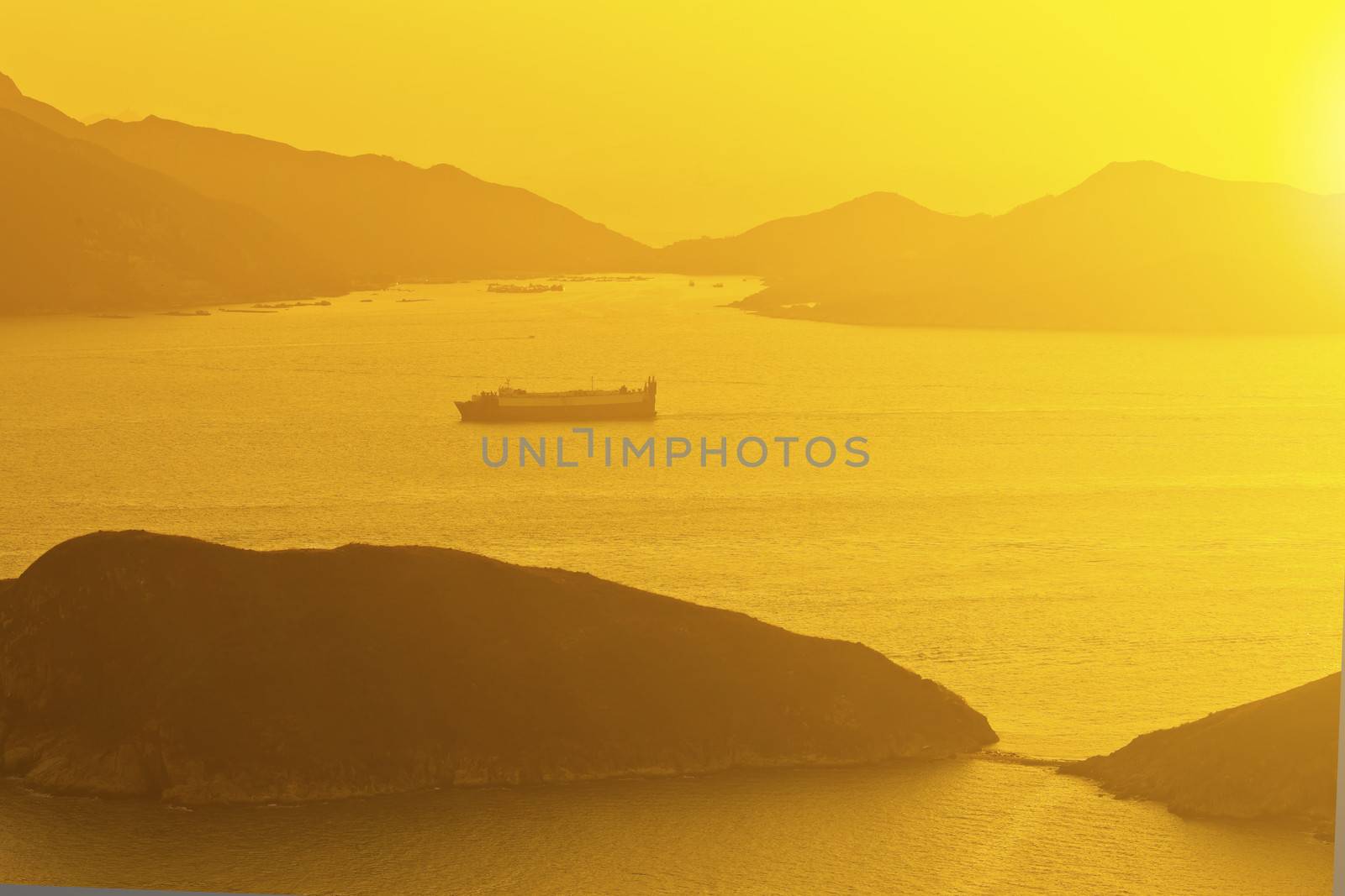 Sunset ocean along mountains with moving ships by kawing921