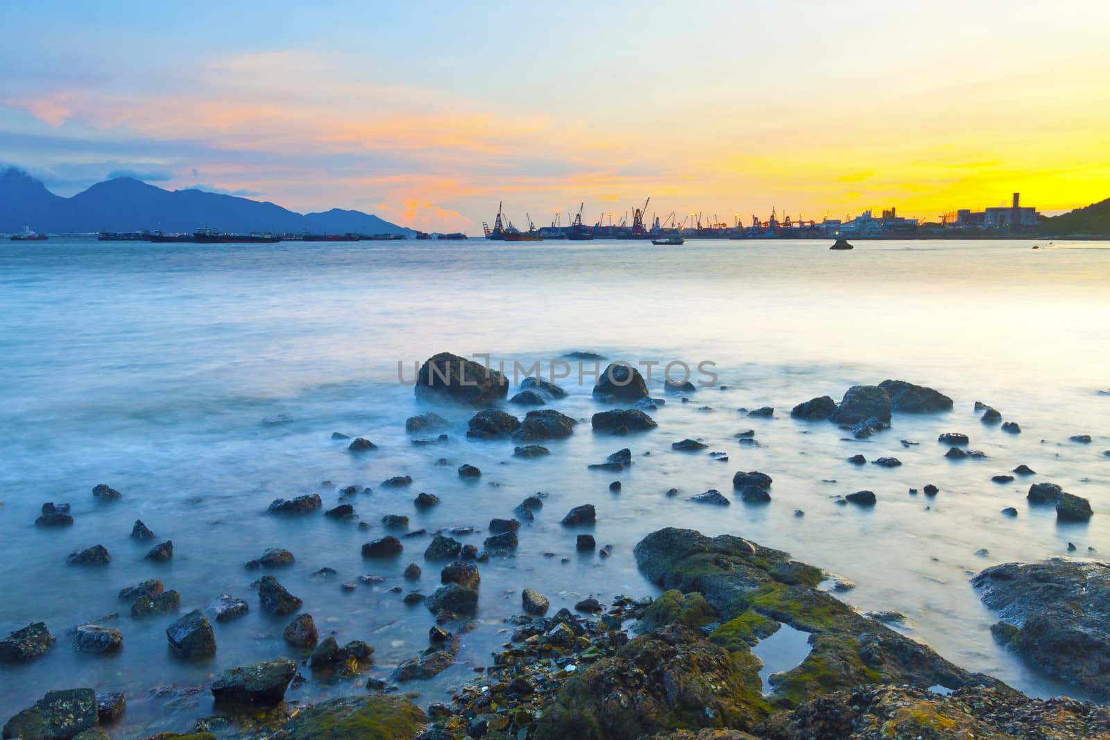 Sunset along coast with sea stones