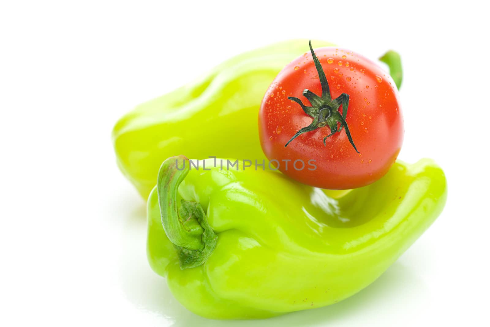 tomatoes and green peppers isolated on white by jannyjus