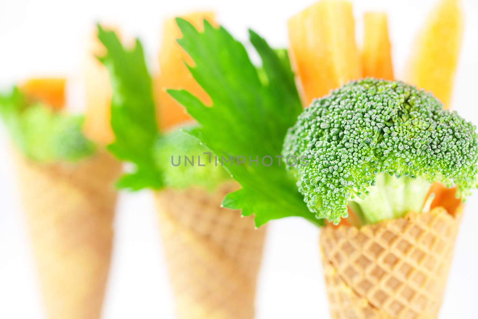 carrot, celery, broccoli in a waffle cone isolated on white by jannyjus