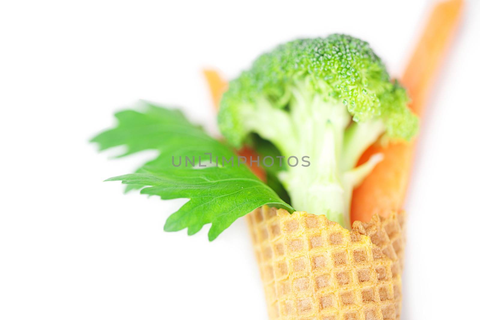 carrot, celery, broccoli in a waffle cone isolated on white