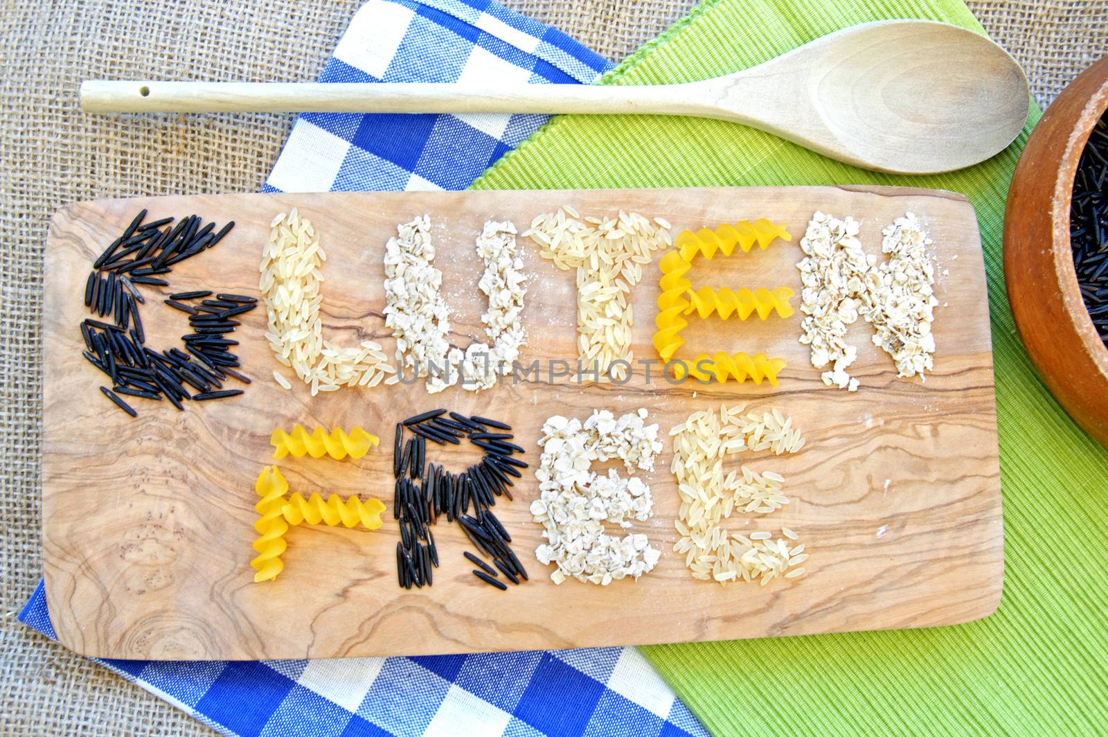 Gluten free grains including rice based pasta and oats over a chopping board 