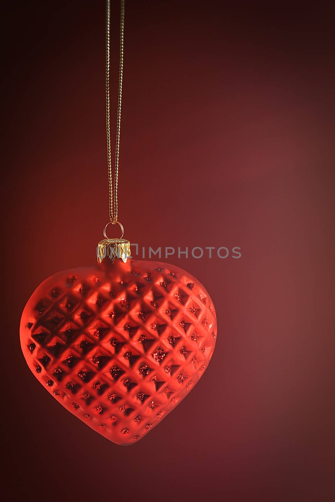 Red heart ornament hanging by Sandralise