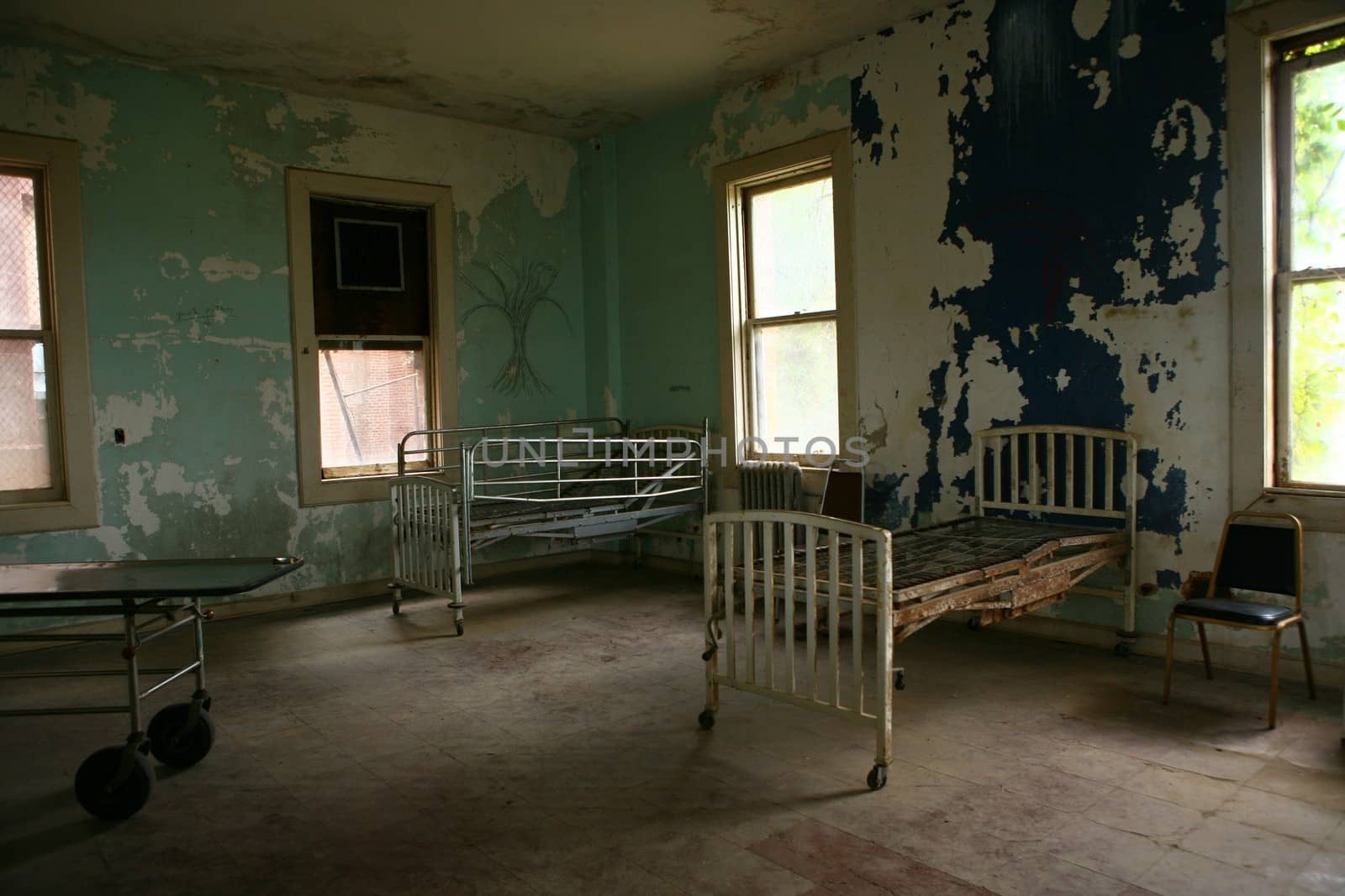 Abandoned Hospital Building With Empty Rusted Beds