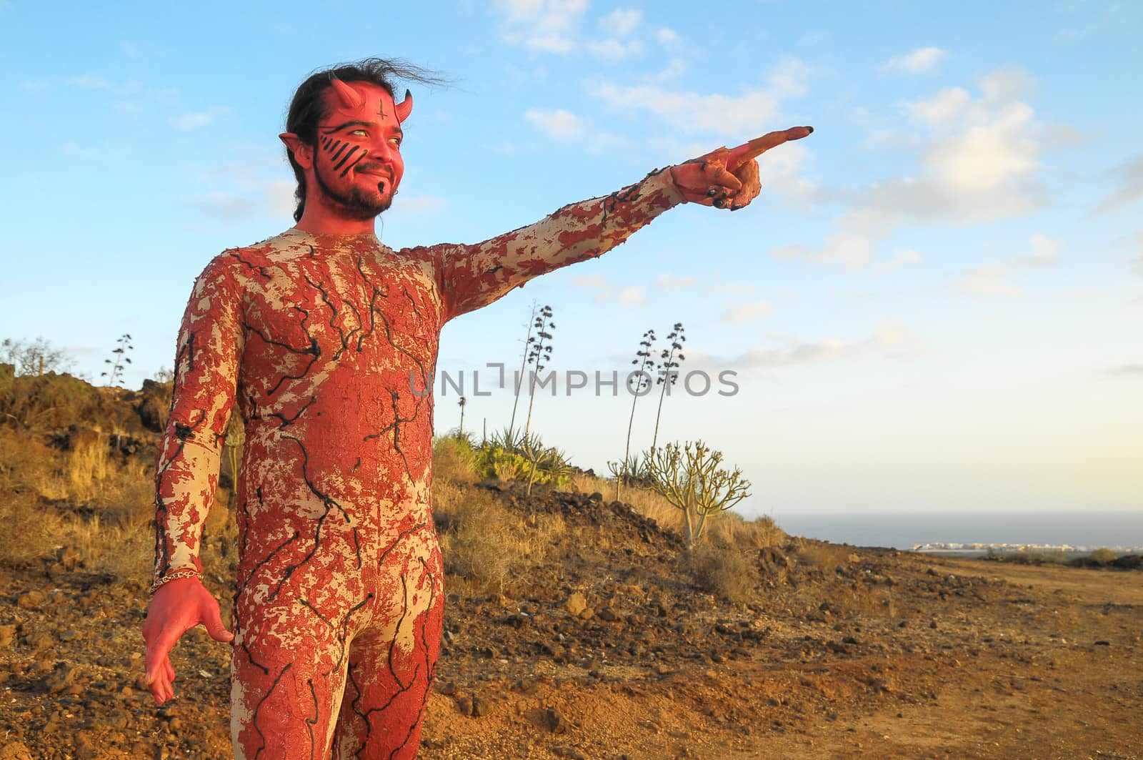 Latin American Man with Long Hairs Masked as a Devil in the Desert