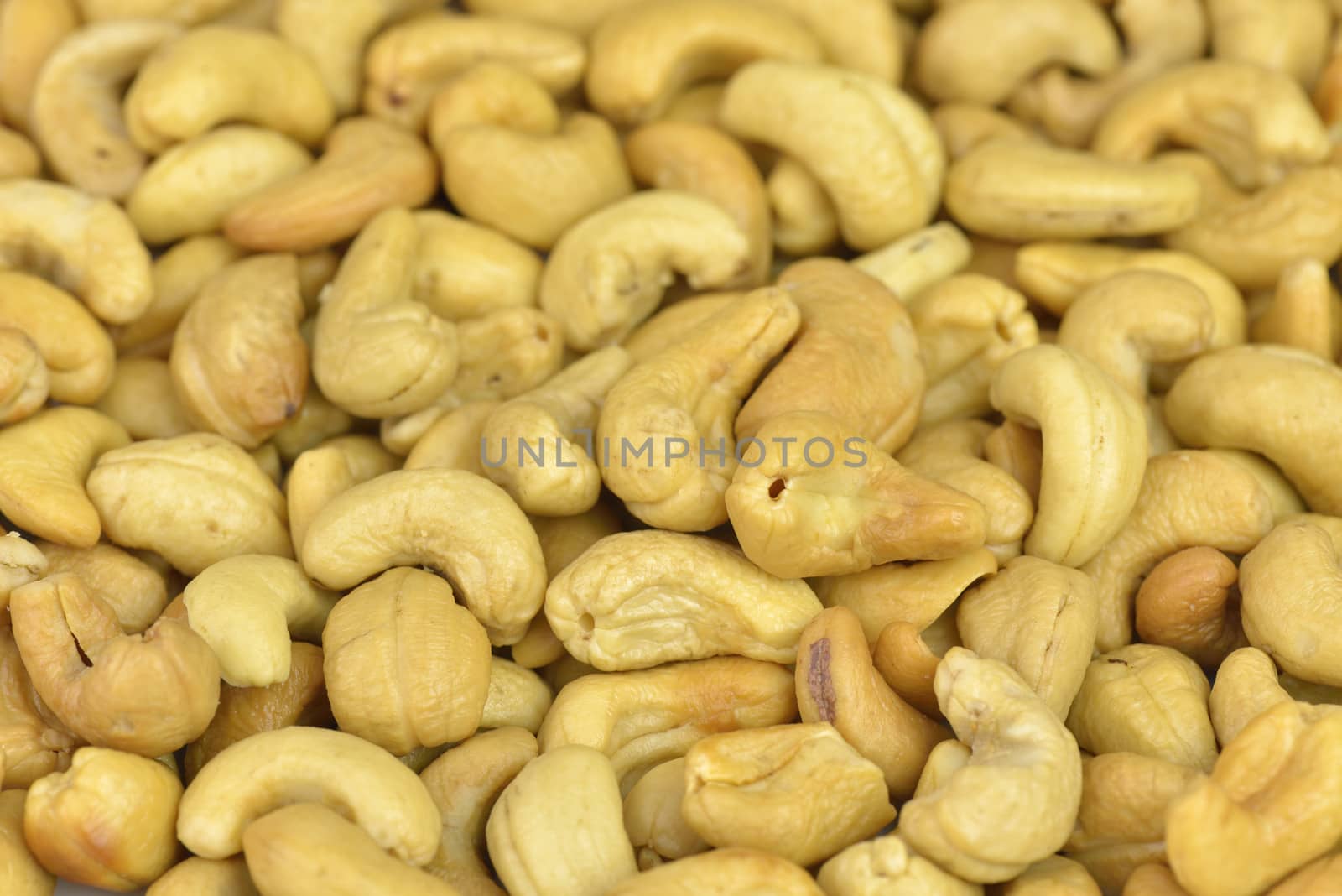 dried and roasted cashews close up on background