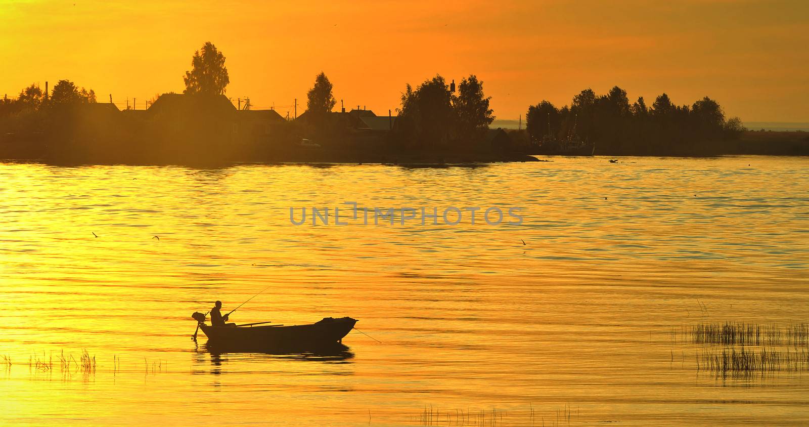 The boat with the fisherman at sunset