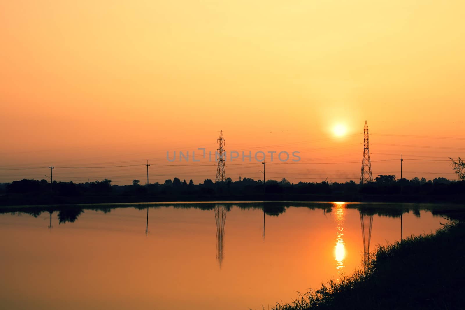 telephone poles on sunset at the river