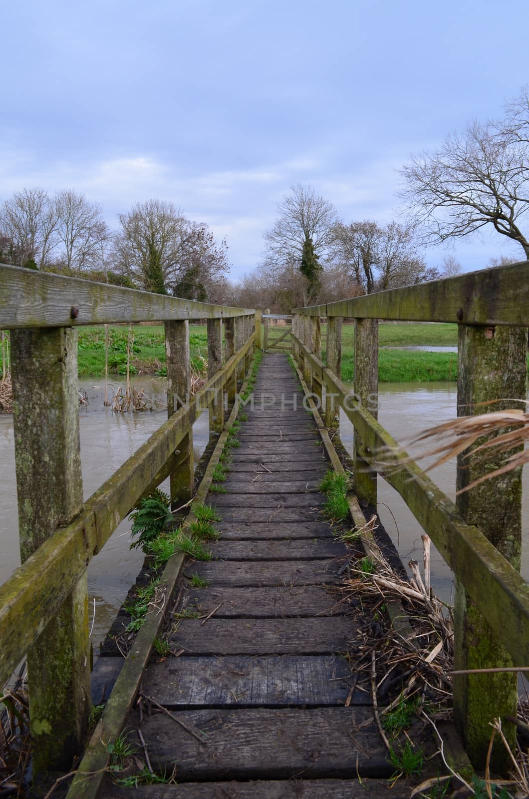 Wooden footbridge crossing a stretch of the River Ouse near Barcombe Mills, Sussex, England.