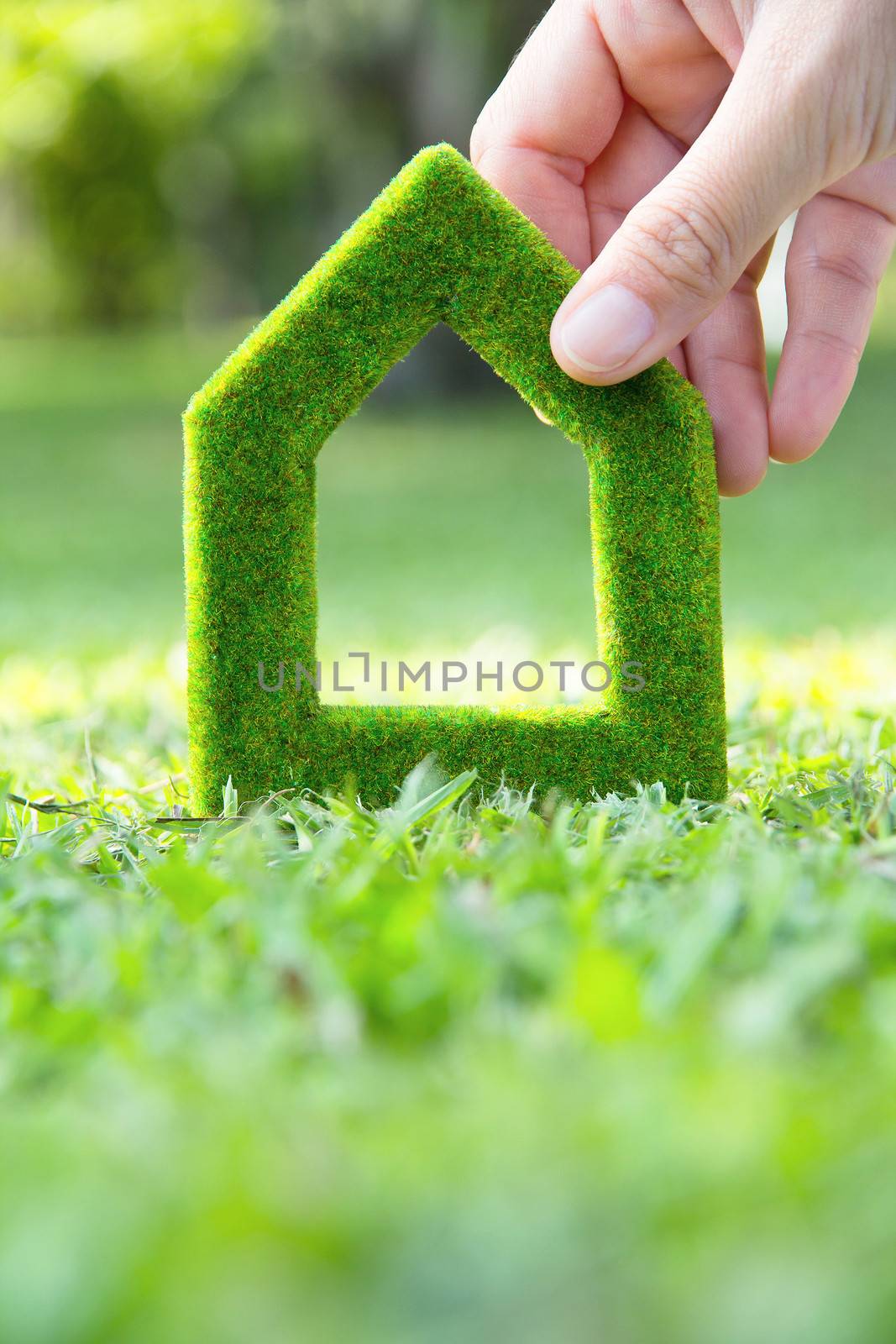 hand holding green house icon concept by ponsulak