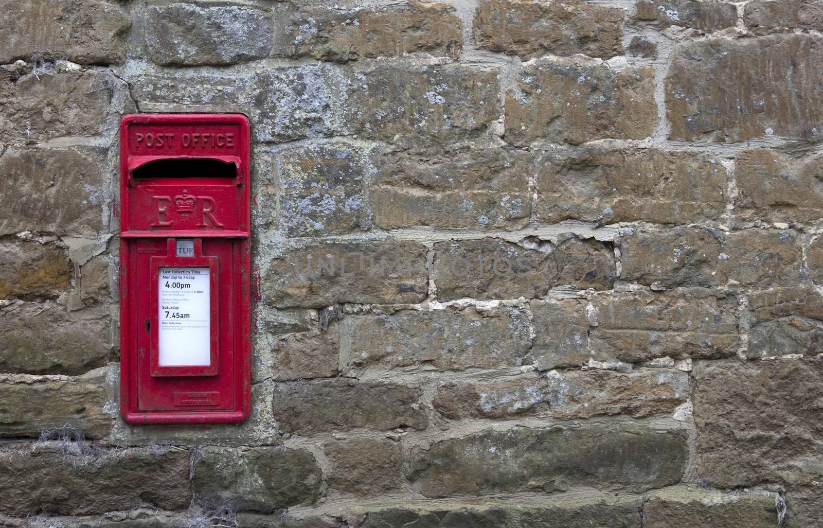 English post box set into a stone wall.