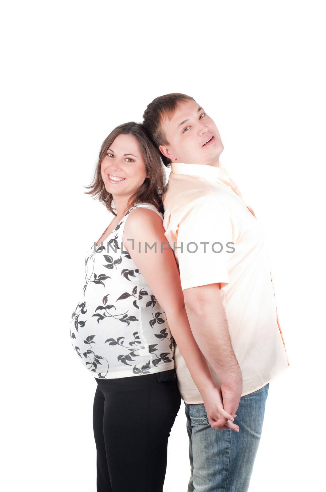 Pregnant woman with her husband standing back to back